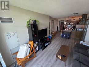 Toronto (Waterfront Communities) condo for rent - A living room with a wooden rocking chair and a coffee table.