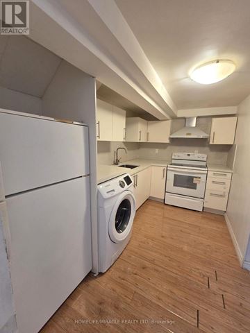 Toronto (L'amoreaux) apartment for rent - A small kitchen with a washing machine and a refrigerator.