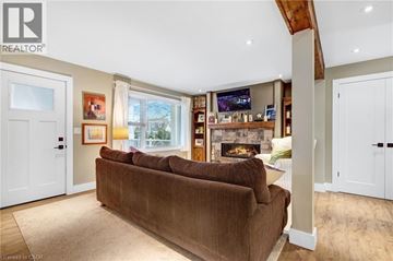 Niagara-On-The-Lake apartment for rent - A living room with a brown couch and a fireplace.