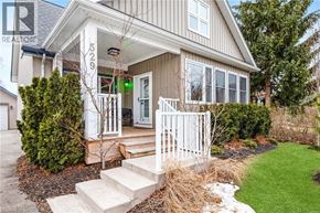 Niagara-On-The-Lake apartment for rent - A house with a white fence and a green sign on the front door.