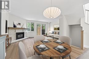 Oakville (Co Central) townhouse for rent - A dining room with a wooden table set for four.