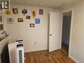 Coquitlam apartment for rent - A room with a white door and a wall with pictures on it.