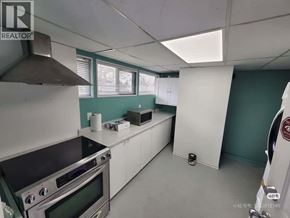 Coquitlam apartment for rent - A kitchen with a stove top oven and a microwave.