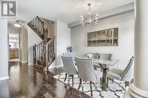 Oakville (Go Glenorchy) townhouse for rent - A dining room with a glass table and grey chairs.