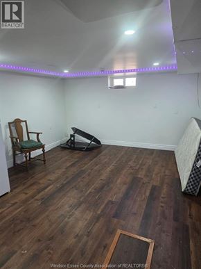 Windsor apartment for rent - A room with wooden floors and a chair.