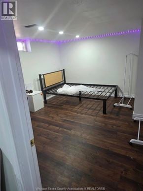 Windsor apartment for rent - A bedroom with a bed and a wooden floor.