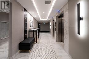 Milton (Walker) condo for rent - A hallway with a bench and elevator doors.