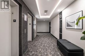 Milton (Walker) condo for rent - A hallway with a bench and a sign that says REALTOR.