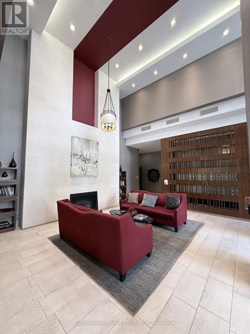 Toronto (Bayview Village) condo for rent - A living room with a red couch and a fireplace.