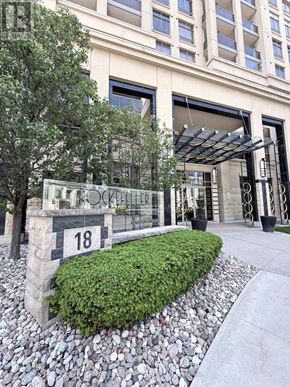 Toronto (Bayview Village) condo for rent - A building with a number 18 on a stone pillar in front of it.