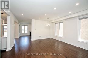 East Gwillimbury (Holland Landing) apartment for rent - A spacious room with wood flooring and white walls.