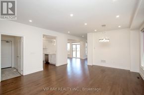 East Gwillimbury (Holland Landing) apartment for rent - A spacious room with wooden floors and white walls, part of a real estate listing.