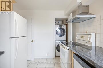 Toronto (Dovercourt-Wallace Emerson-Junction) apartment for rent - A kitchen with a white fridge, a washing machine, a dishwasher and a microwave.