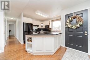 Brantford apartment for rent - A kitchen with a black door and a wreath on it.