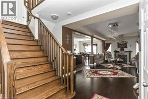Hamilton apartment for rent - A wooden staircase leads to a brightly lit living room.