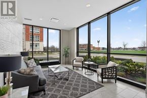 Kitchener condo for rent - A living room with a large window and a view of a street.