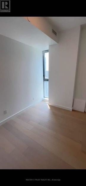 Toronto (Church-Yonge Corridor) condo for rent - A room with wooden flooring and white walls.