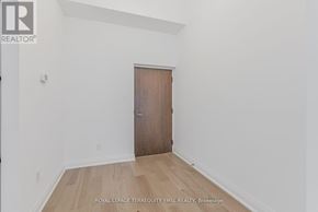 Toronto (Waterfront Communities) condo for rent - A room with a wooden door and a white wall.
