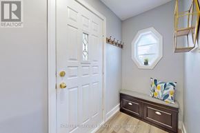 Toronto (O'connor-Parkview) apartment for rent - A white door with a gold handle is in a room with a bench and a mirror.