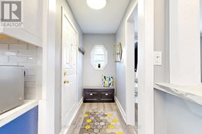 Toronto (O'connor-Parkview) apartment for rent - A hallway with a bench and a rug with yellow flowers.