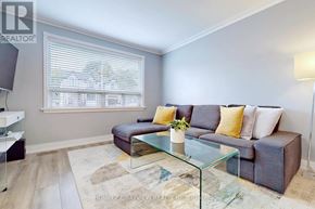 Toronto (O'connor-Parkview) apartment for rent - A living room with a couch, coffee table, and a window with blinds.