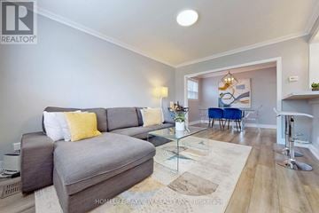 Toronto (O'connor-Parkview) apartment for rent - A living room with a grey couch and a glass coffee table.