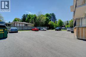 Waterloo apartment for rent - A parking lot with cars and a REALTOR sign.
