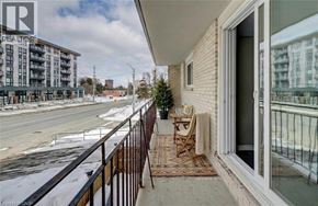 Waterloo apartment for rent - A balcony with a chair and a table is overlooking a snowy street.