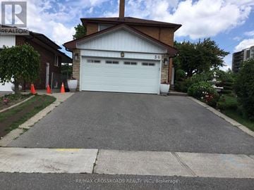 Toronto (Willowridge-Martingrove-Richview) apartment for rent - A garage with a white door is in front of a house.