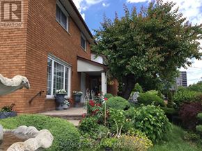 Toronto (Willowridge-Martingrove-Richview) apartment for rent - A red brick house with a garden in front.