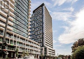 Toronto (Don Valley Village) condo for rent - A modern building with a glass facade stands tall next to a shorter building with a white facade.