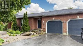 Georgina (Historic Lakeshore Communities) apartment for rent - A house with a brick facade and two garage doors is for sale.