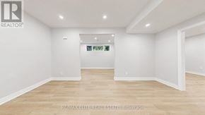 Georgina (Historic Lakeshore Communities) apartment for rent - A white room with a wooden floor and a white wall with a window.