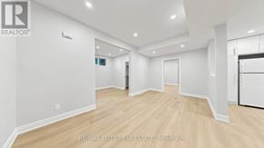 Georgina (Historic Lakeshore Communities) apartment for rent - A spacious room with wooden flooring and white walls.