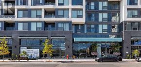 Oakville (Wm Westmount) condo for rent - A modern multi-story building with a glass entrance and a sign that says "Walgreens".