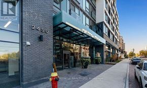 Oakville (Wm Westmount) condo for rent - A street view of a building with the number 2450 on it and a fire hydrant in front.