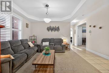 Brampton (Northwest Brampton) apartment for rent - A living room with a grey sofa and a wooden coffee table.