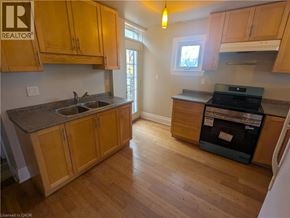 Hamilton apartment for rent - A kitchen with wooden cabinets and a black dishwasher.