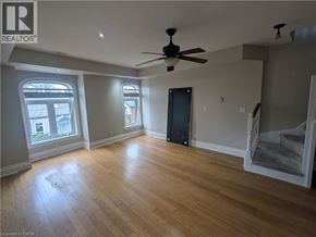 Hamilton apartment for rent - A room with a ceiling fan and wooden flooring.
