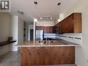 Pitt Meadows apartment for rent - A kitchen with a brown island and wooden cabinets.