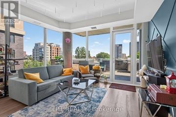 Ottawa condo for rent - A living room with a grey couch and a glass table.