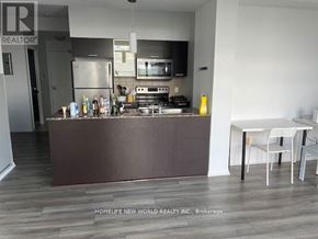 Toronto (Bay Street Corridor) condo for rent - A kitchen with a brown island and white chairs.
