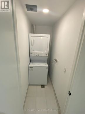 Toronto (Englemount-Lawrence) condo for rent - A white toilet in a narrow hallway.
