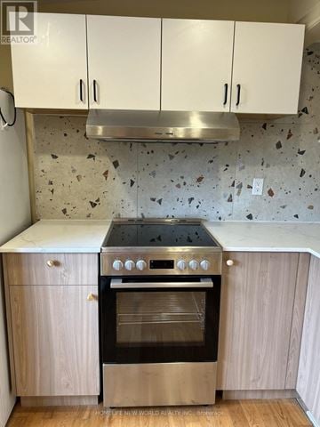 Toronto (Rockcliffe-Smythe) apartment for rent - A kitchen with a stove top oven and cabinets.