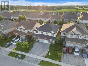 Guelph (Grange Road) apartment for rent - A bird's eye view of a residential area with houses and cars.
