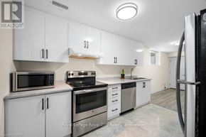 Guelph (Grange Road) apartment for rent - A kitchen with white cabinets and stainless steel appliances.