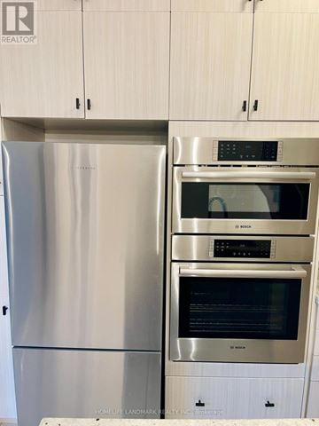 Vaughan (Patterson) townhouse for rent - A stainless steel refrigerator and oven in a kitchen.