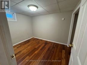 Toronto (Brookhaven-Amesbury) apartment for rent - A room with wooden flooring and white walls.