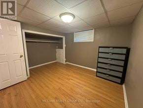 Toronto (Brookhaven-Amesbury) apartment for rent - A brokerage office with a white door and a wooden floor.
