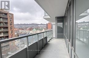Hamilton (Beasley) condo for rent - A balcony with a glass railing and a view of the city.